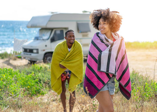 Young couple in love enjoying their romantic summer vacation with camper.